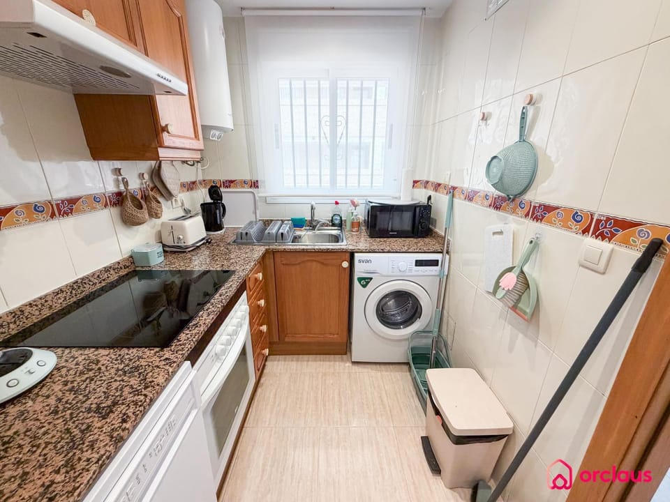 Kitchen or kitchenette, dishwasher, oven, stove, washing machine