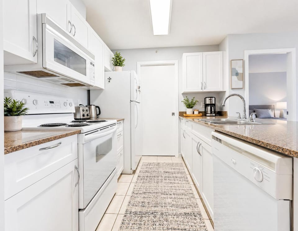 Kitchen or kitchenette, dishwasher, oven, stove