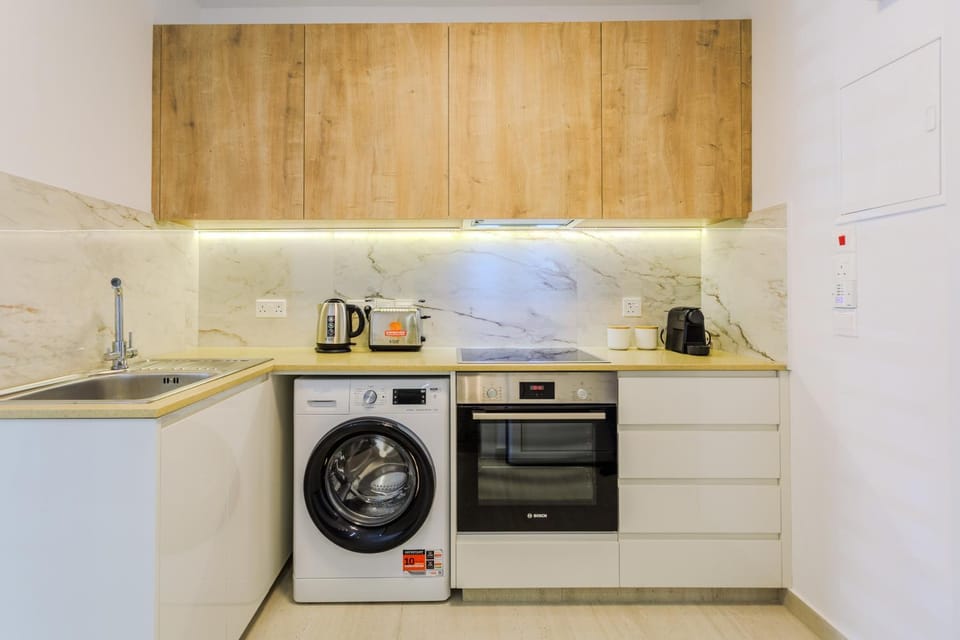 Kitchen or kitchenette, oven, stove, toaster, washing machine