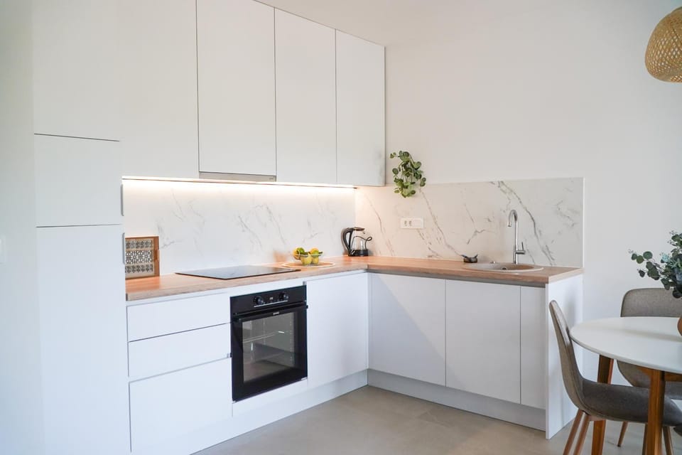 Kitchen or kitchenette, dishwasher, oven, stove