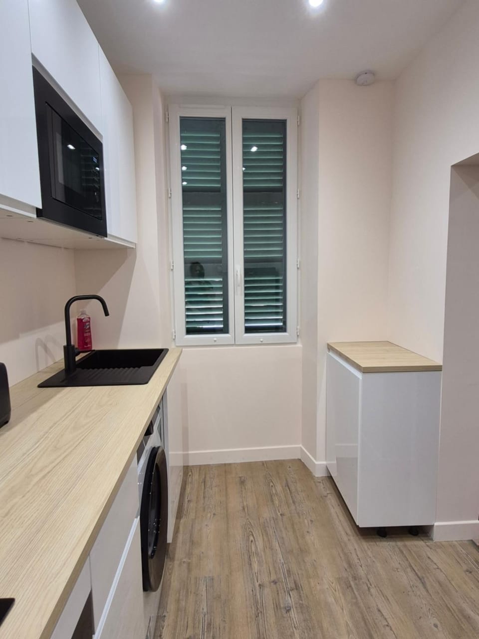 Kitchen or kitchenette, microwave, oven, stove, washing machine