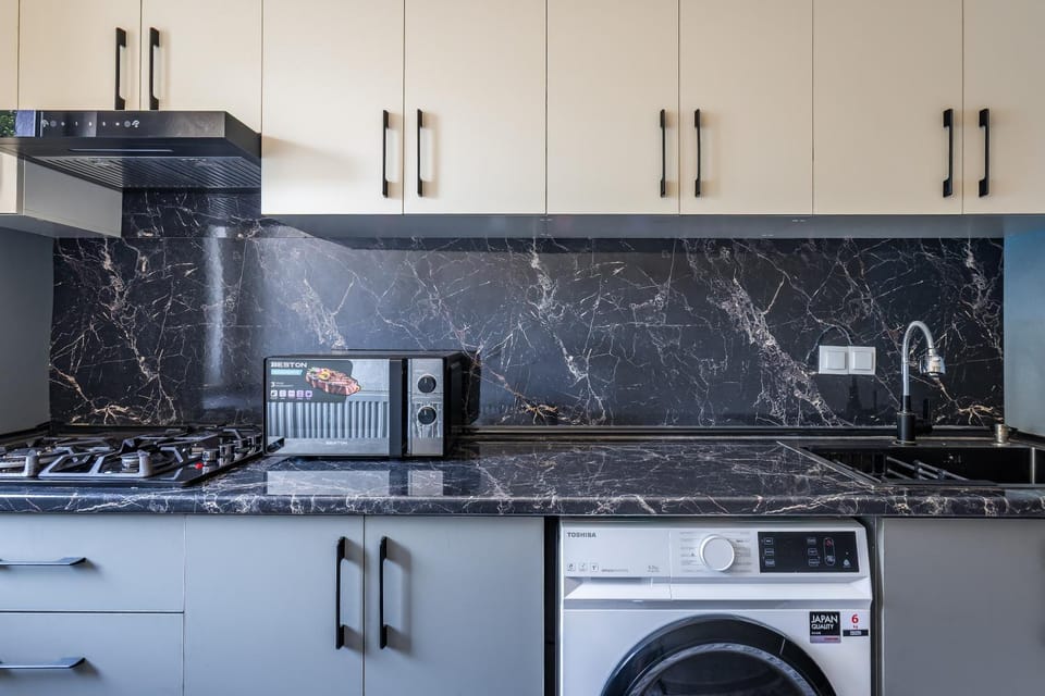 Kitchen or kitchenette, microwave, oven, stove, washing machine