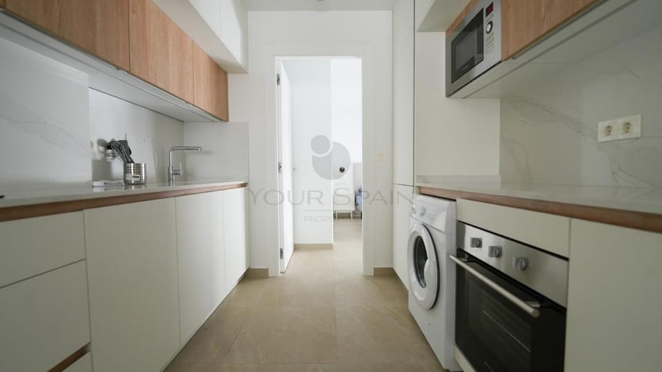 Kitchen or kitchenette, microwave, oven, stove, washing machine