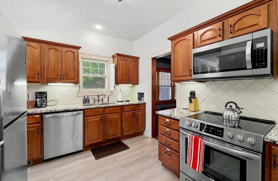 Kitchen or kitchenette, dishwasher, oven, stove