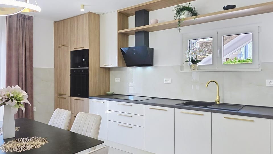 Kitchen or kitchenette, dishwasher, oven, stove