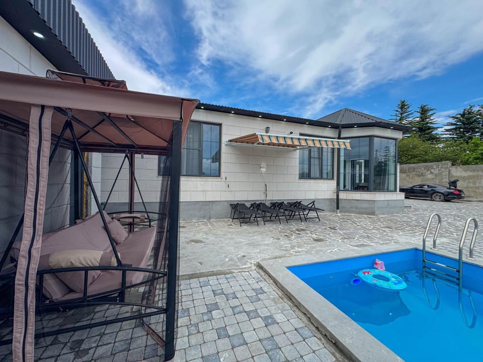 Property building, Patio, Day, Natural landscape, Pool view, Swimming pool, sunbed
