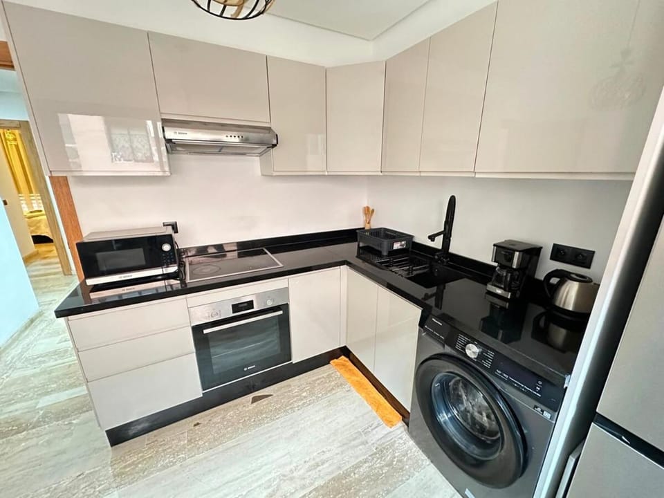 Kitchen or kitchenette, dishwasher, oven, stove, toaster, washing machine