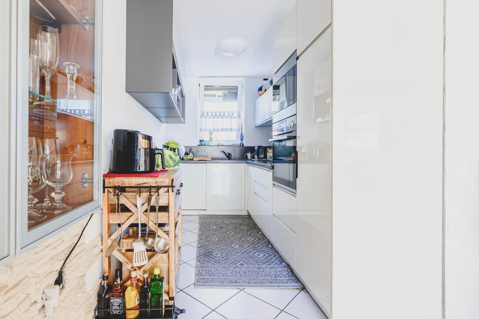 Kitchen or kitchenette, dishwasher, oven, stove