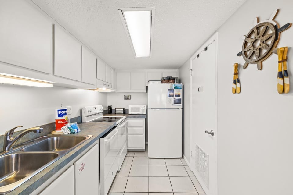 Kitchen or kitchenette, dishwasher, microwave, oven, stove