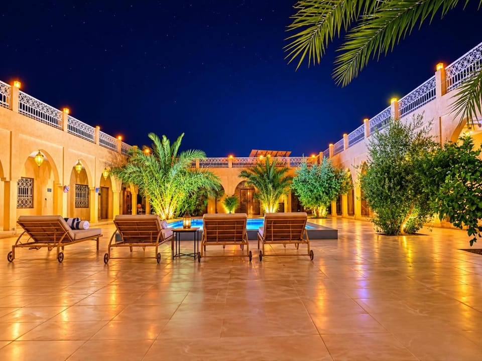 Property building, Patio, Night, Seating area, Pool view, Swimming pool, sunbed