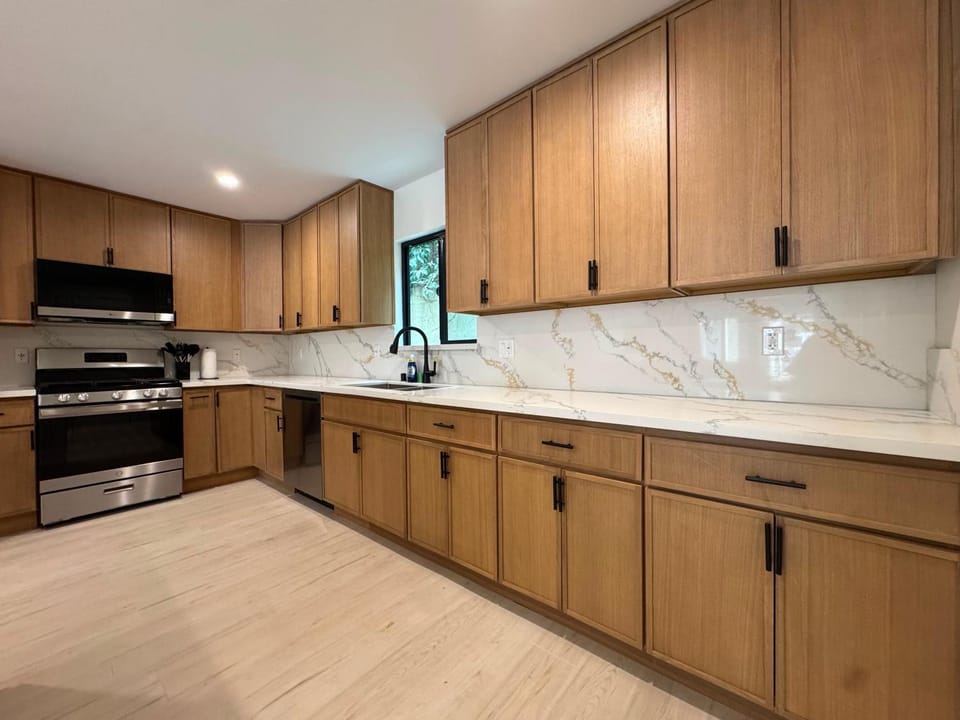 Kitchen or kitchenette, dishwasher, oven, stove