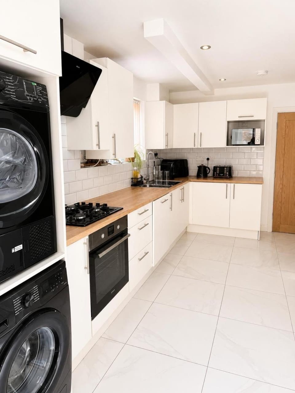 Kitchen or kitchenette, dishwasher, oven, stove, toaster, washing machine, dryer