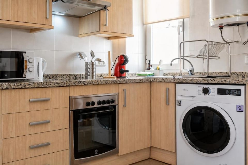 Kitchen or kitchenette, stove, toaster, washing machine