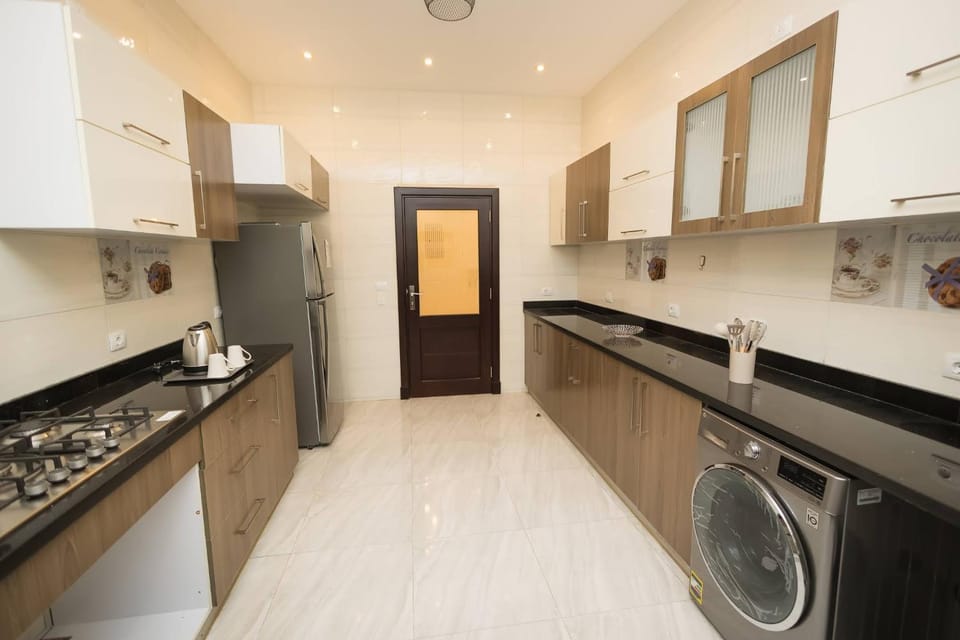 Kitchen or kitchenette, stove, washing machine, dryer