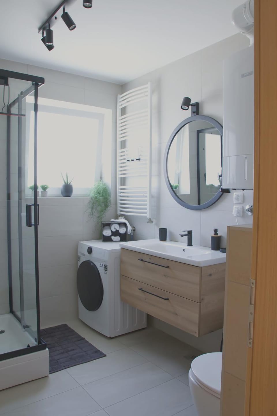 Shower, Toilet, Bathroom, hair dryier, towels, washing machine, dryer
