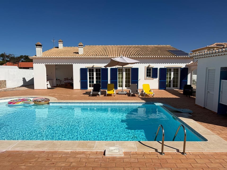 Property building, Patio, Pool view, Swimming pool, sunbed