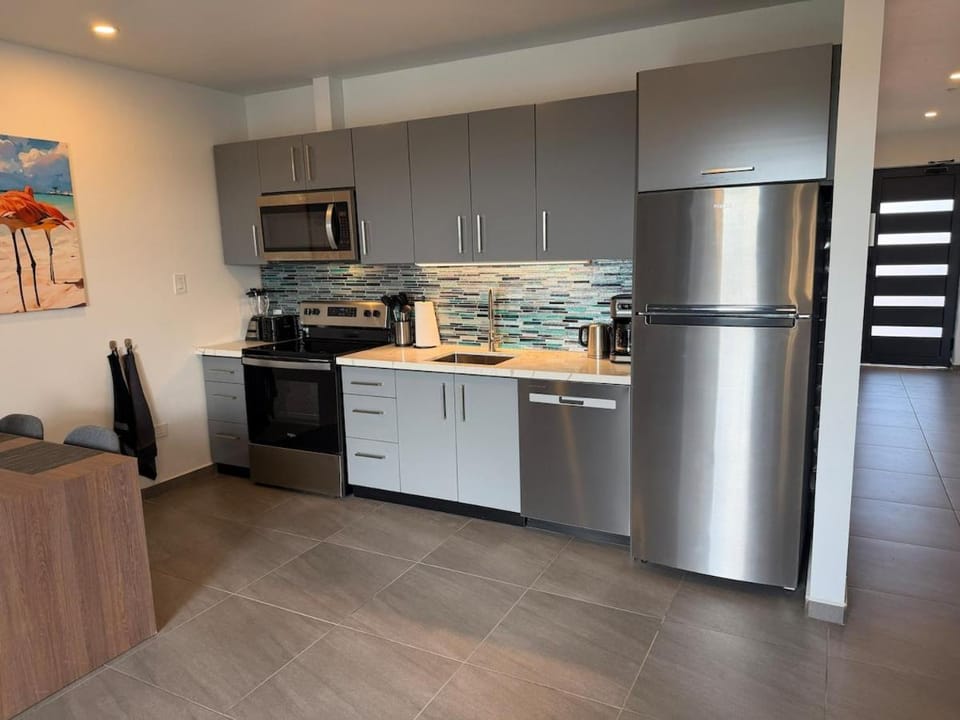 Kitchen or kitchenette, dishwasher, oven, stove