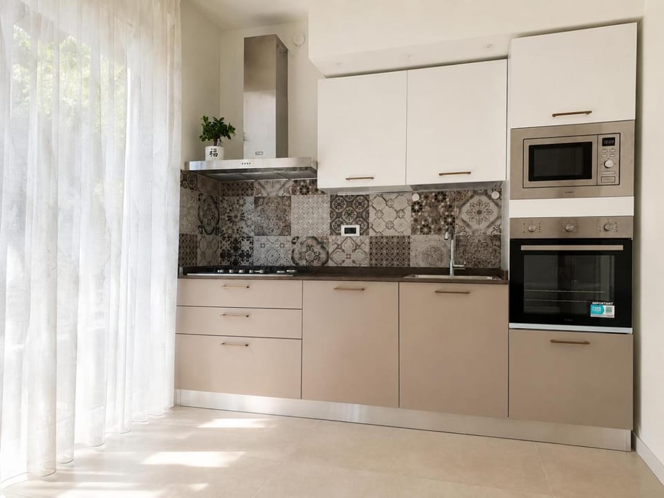 Kitchen or kitchenette, dishwasher, oven, stove