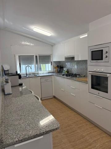 Kitchen or kitchenette, dishwasher, oven, stove, toaster