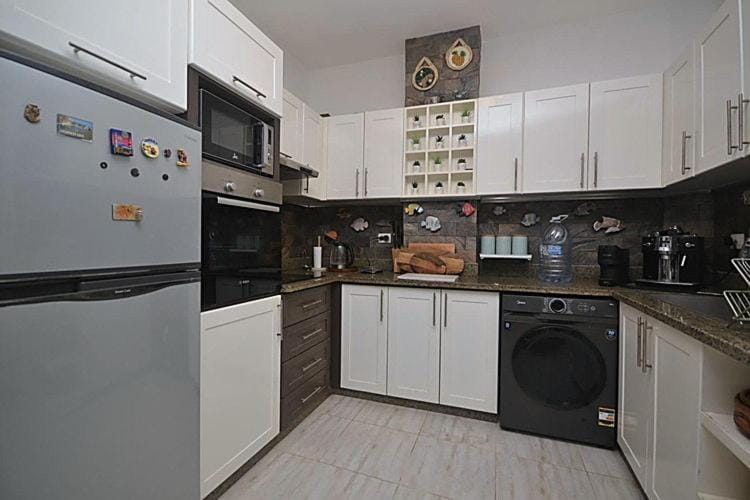 Kitchen or kitchenette, microwave, oven, stove, washing machine
