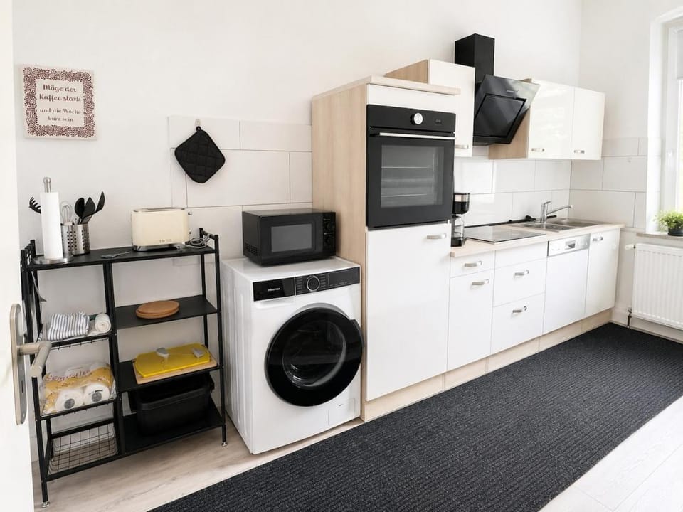 Kitchen or kitchenette, dishwasher, oven, stove, toaster, washing machine