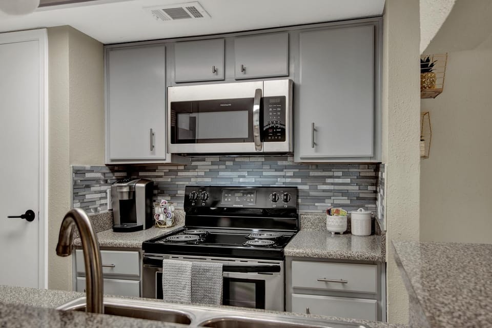 Kitchen or kitchenette, microwave, oven, stove, toaster, kitchen, air conditioner