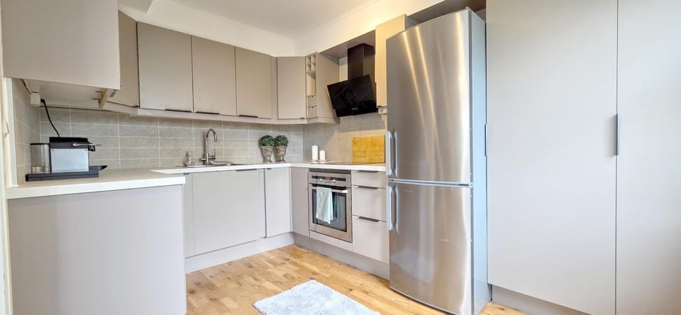 Kitchen or kitchenette, dishwasher, oven, stove