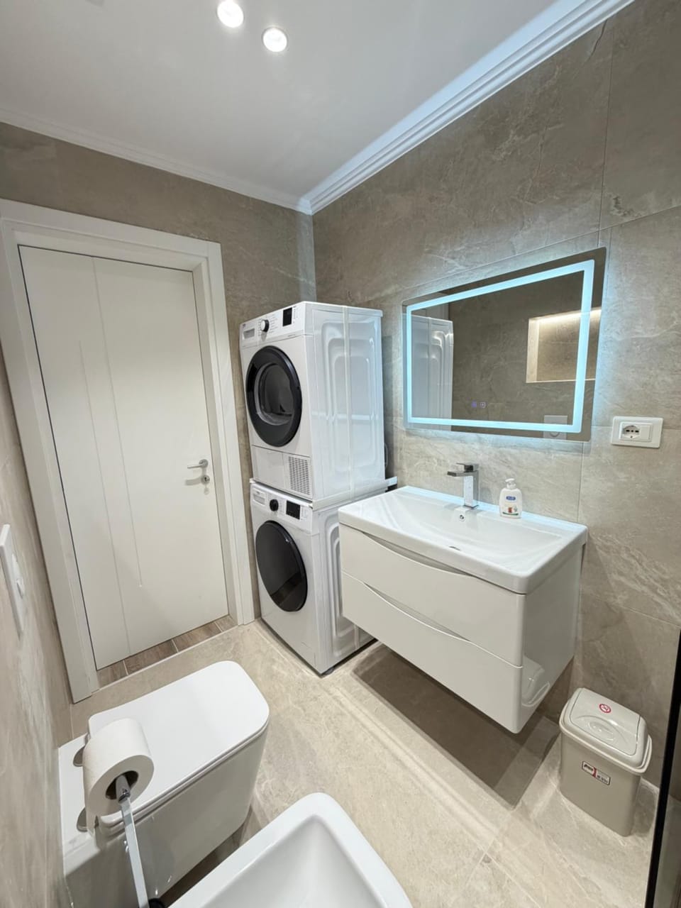 Shower, Toilet, Bathroom, hair dryier, towels, washing machine, dryer