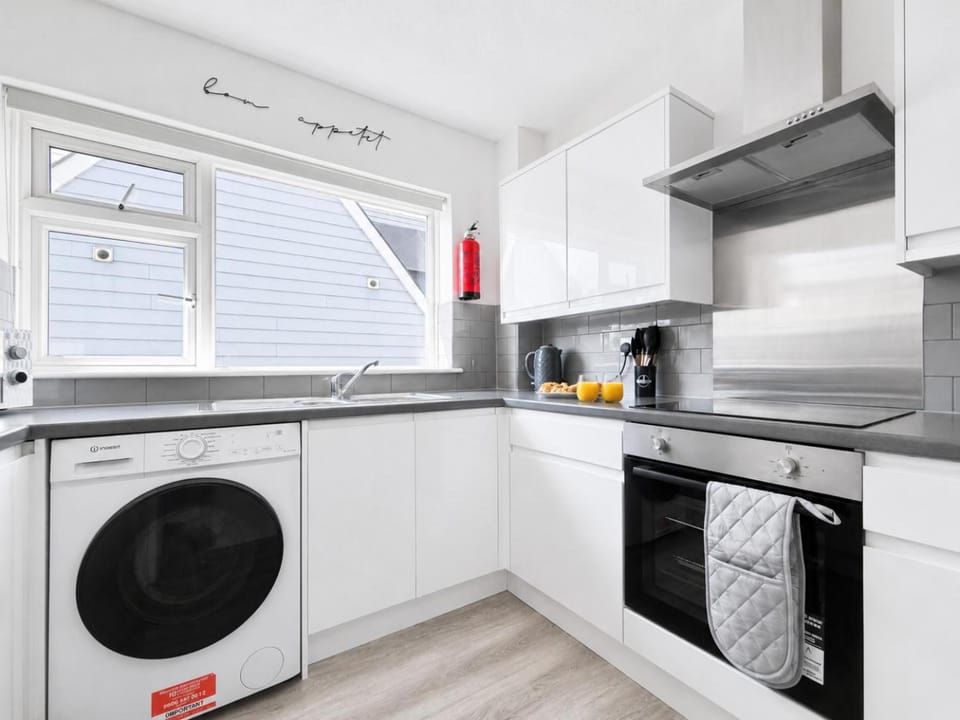 Kitchen or kitchenette, dishwasher, oven, stove, toaster, washing machine