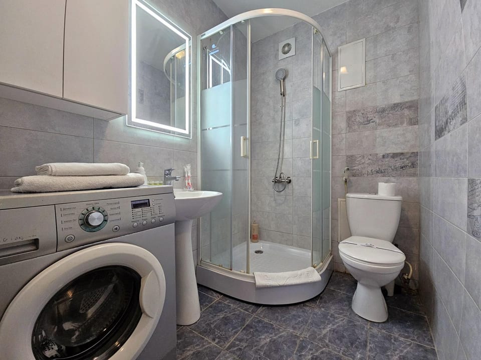 Shower, Toilet, Bathroom, bidet, towels, washing machine, dryer