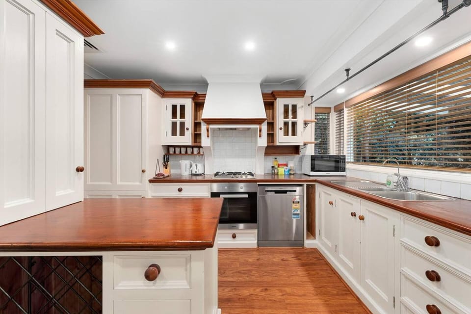 Kitchen or kitchenette, dishwasher, microwave, oven, stove
