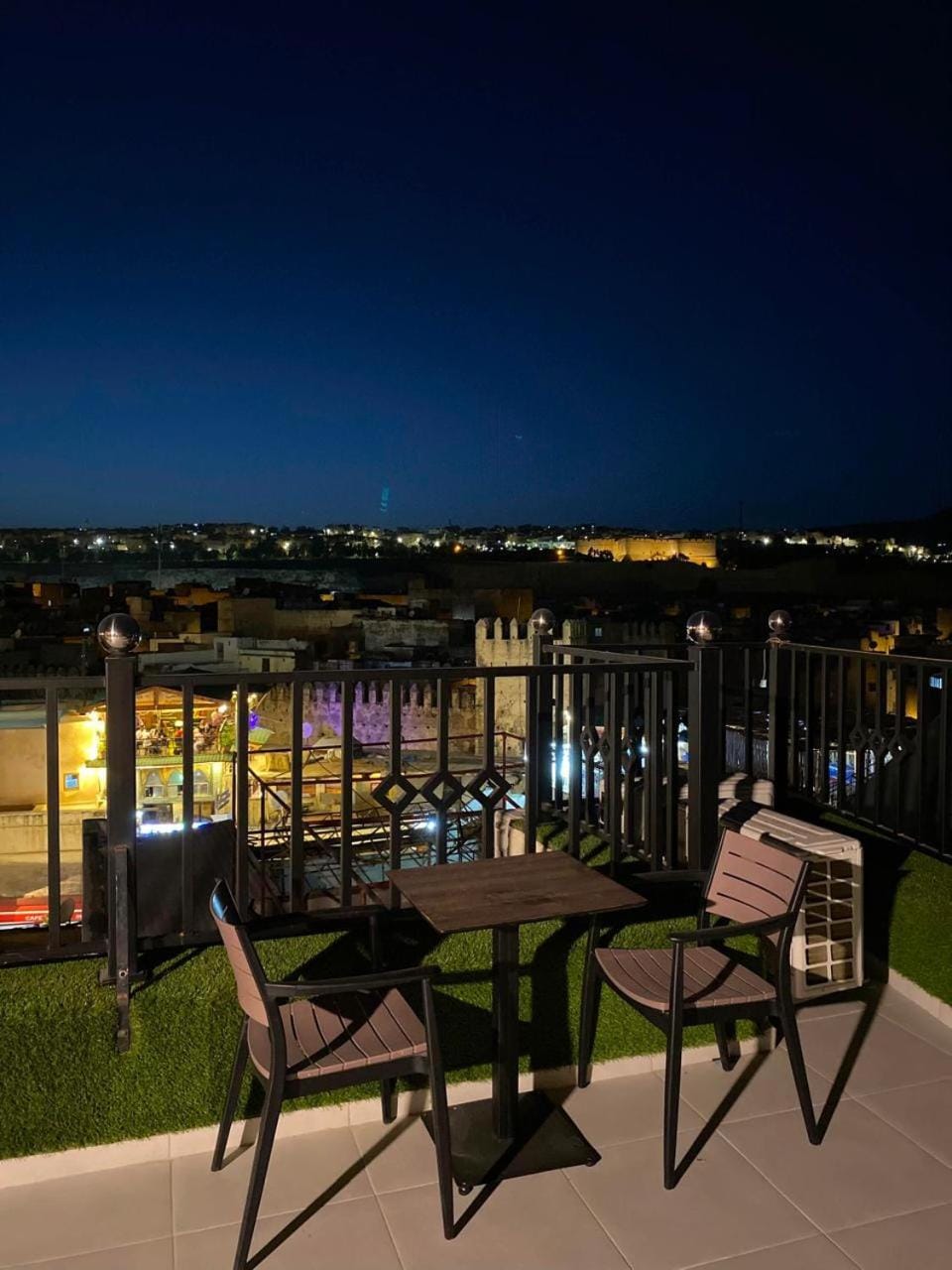 Property building, Patio, Night, View (from property/room), Balcony/Terrace, Living room, Seating area, Dining area