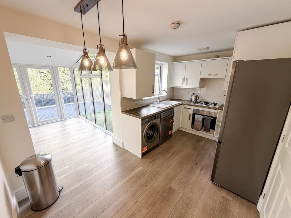 Kitchen or kitchenette, dishwasher, oven, stove, toaster, washing machine