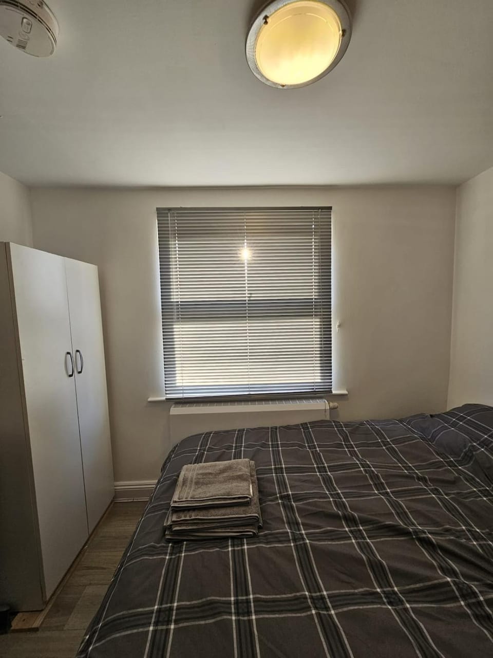 Bed, towels, wardrobe