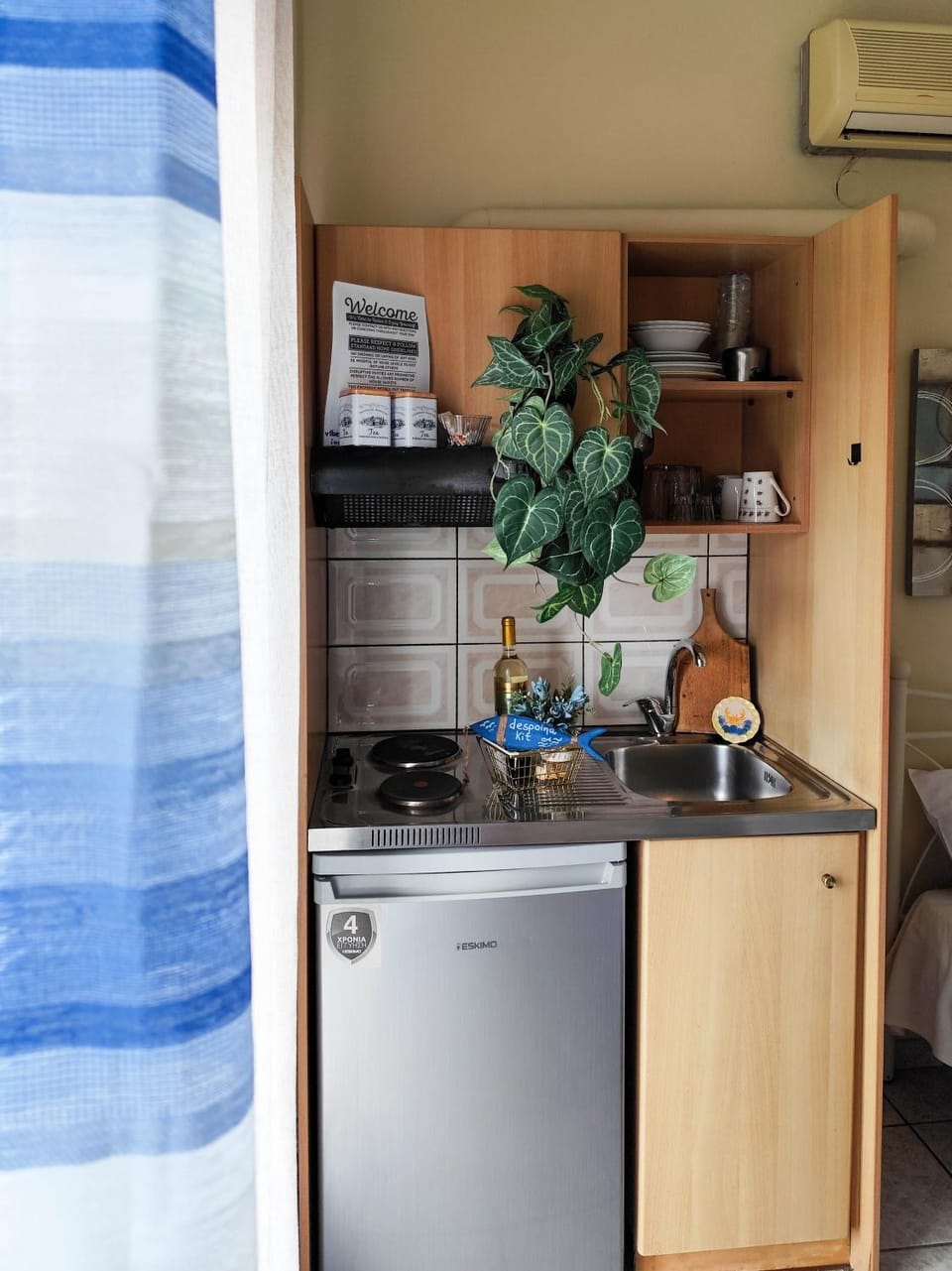 Kitchen or kitchenette, stove, air conditioner