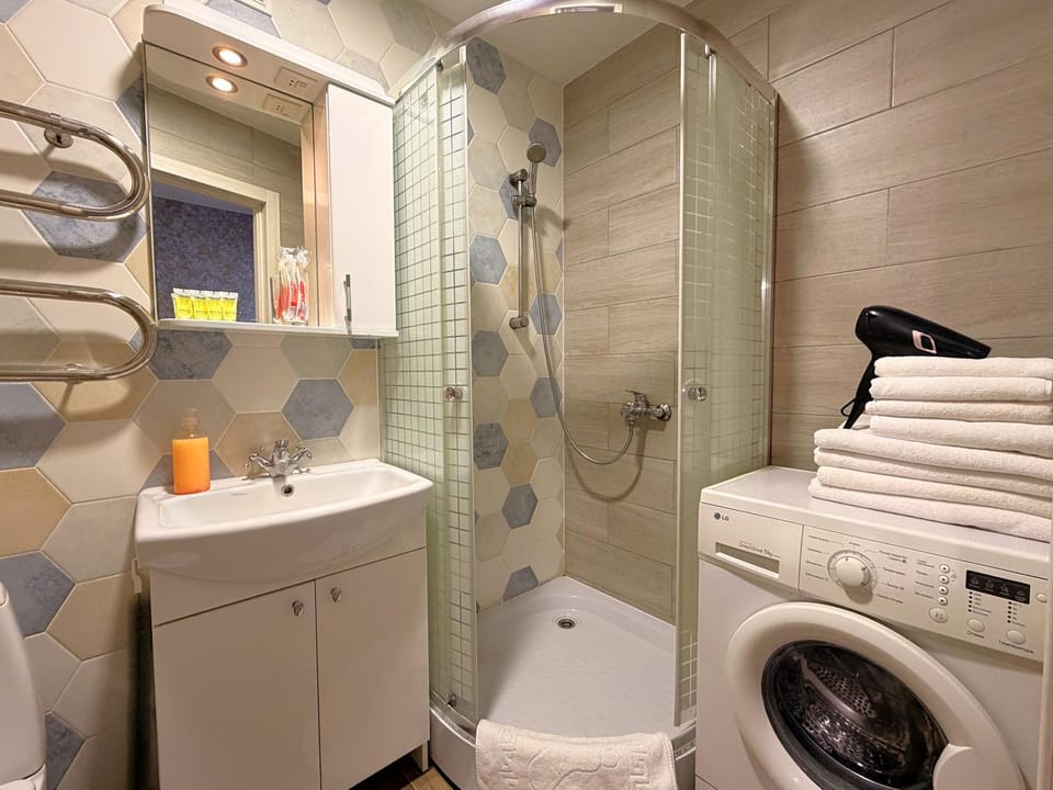 Shower, Toilet, Bathroom, hair dryier, towels, washing machine, dryer