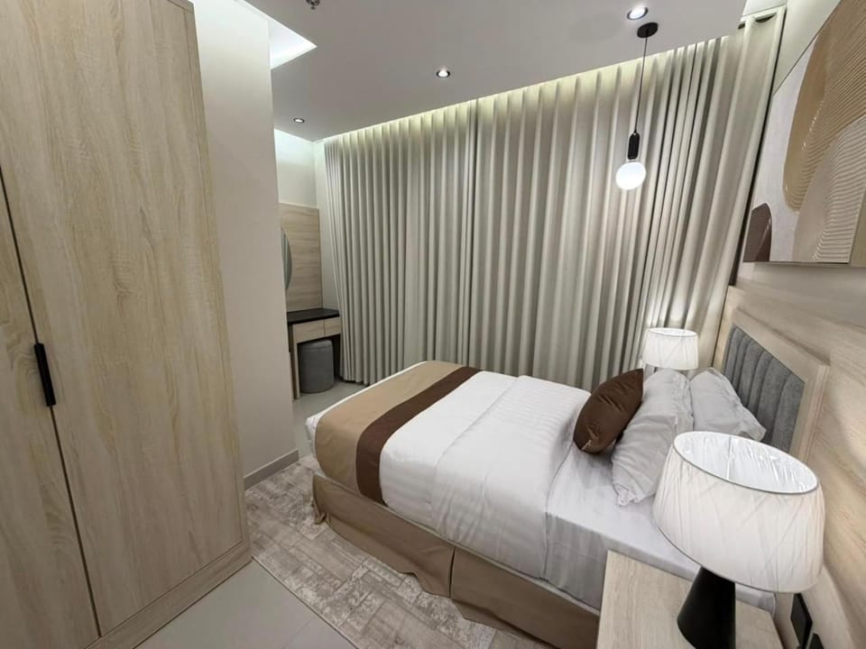 Bed, towels, wardrobe