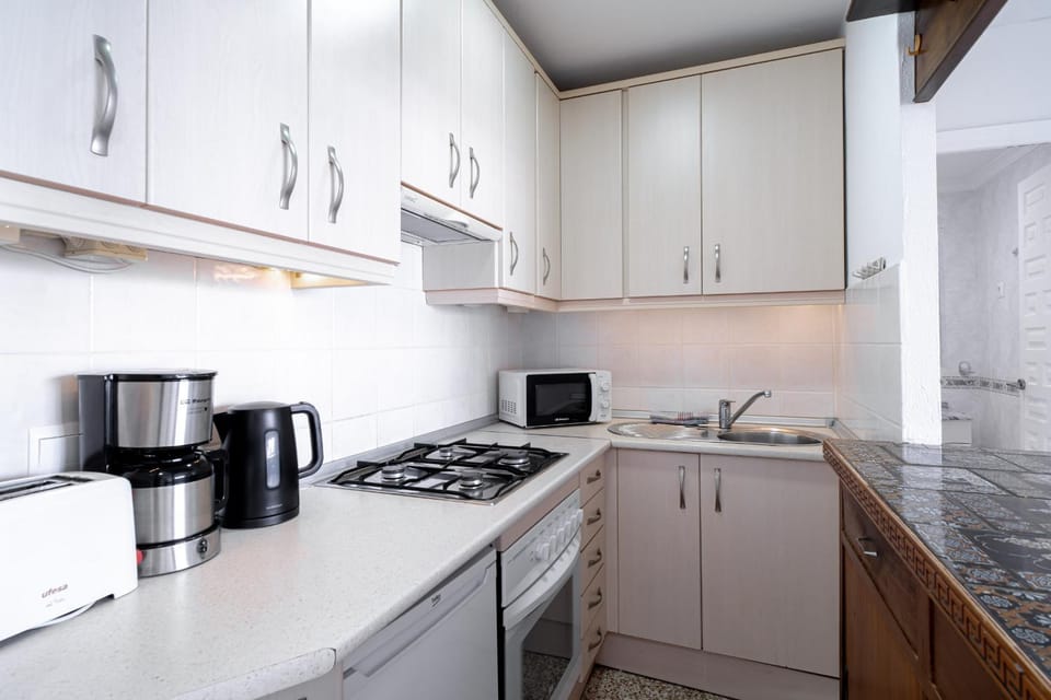 Kitchen or kitchenette, dishwasher, oven, stove, toaster