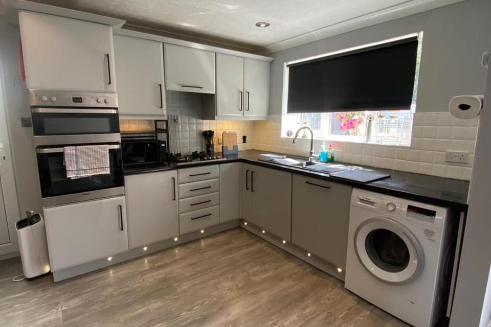 Kitchen or kitchenette, dishwasher, oven, washing machine, dryer