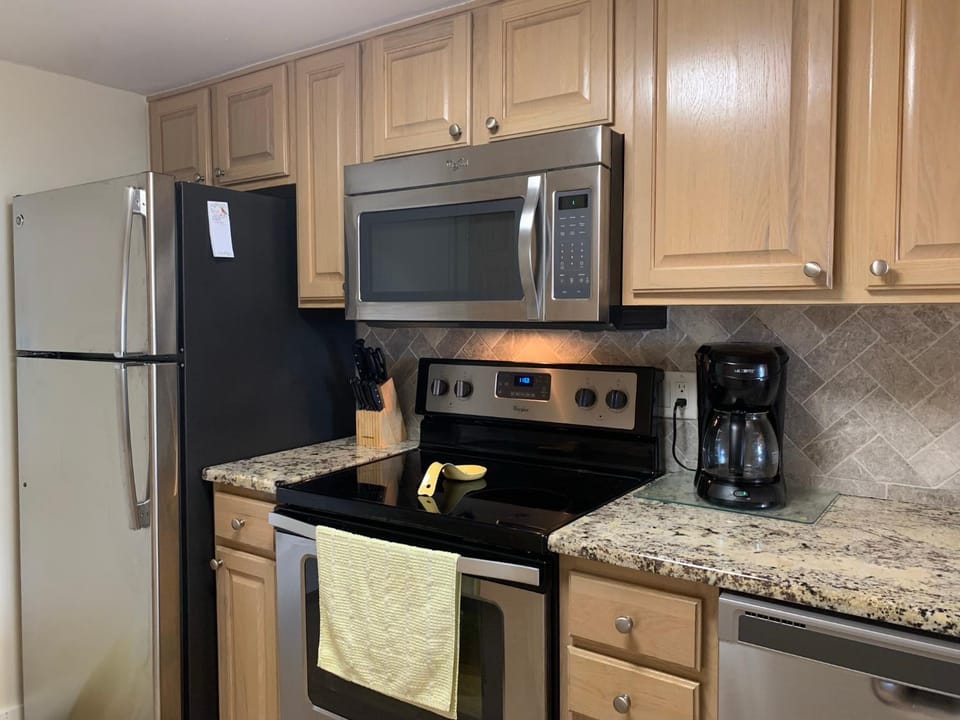 Kitchen or kitchenette, dishwasher, oven, stove