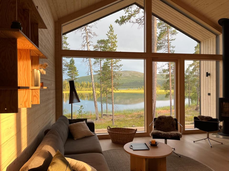 Natural landscape, Living room, Seating area, Lake view, Mountain view, Seasons, Time of day, Sunset, fireplace