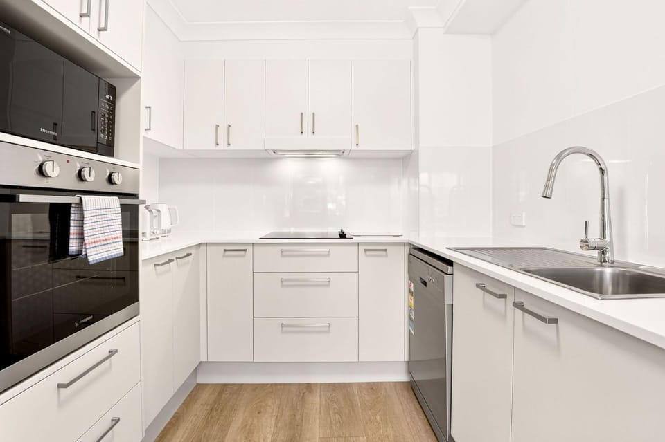 Kitchen or kitchenette, dishwasher, oven, stove