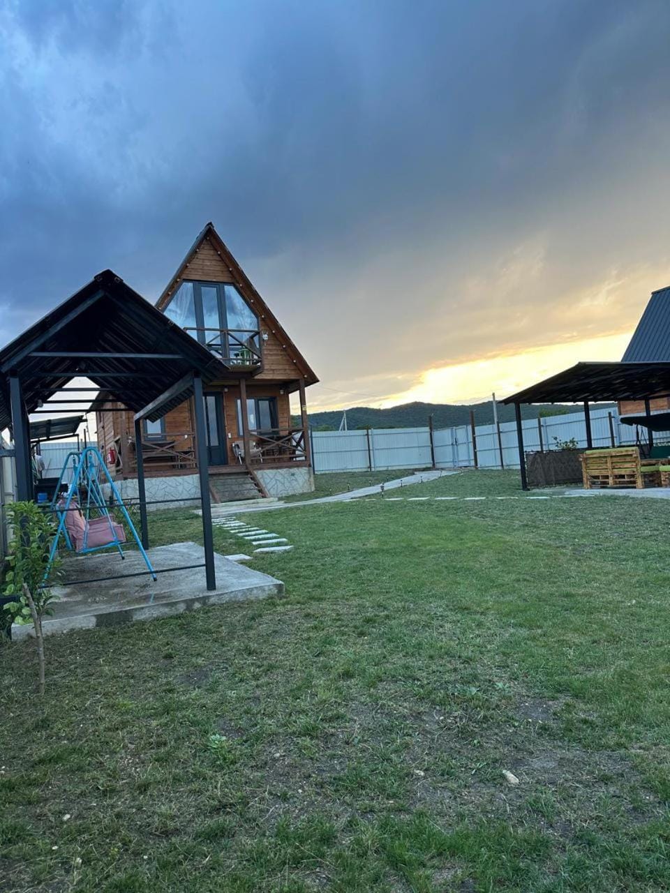 Property building, Day, Natural landscape, Seating area, Lake view, Landmark view, Time of day, Sunset