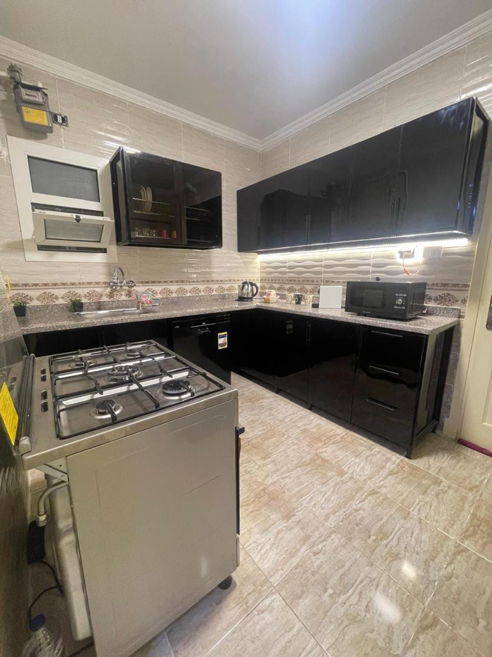 Kitchen or kitchenette, dishwasher, oven, stove