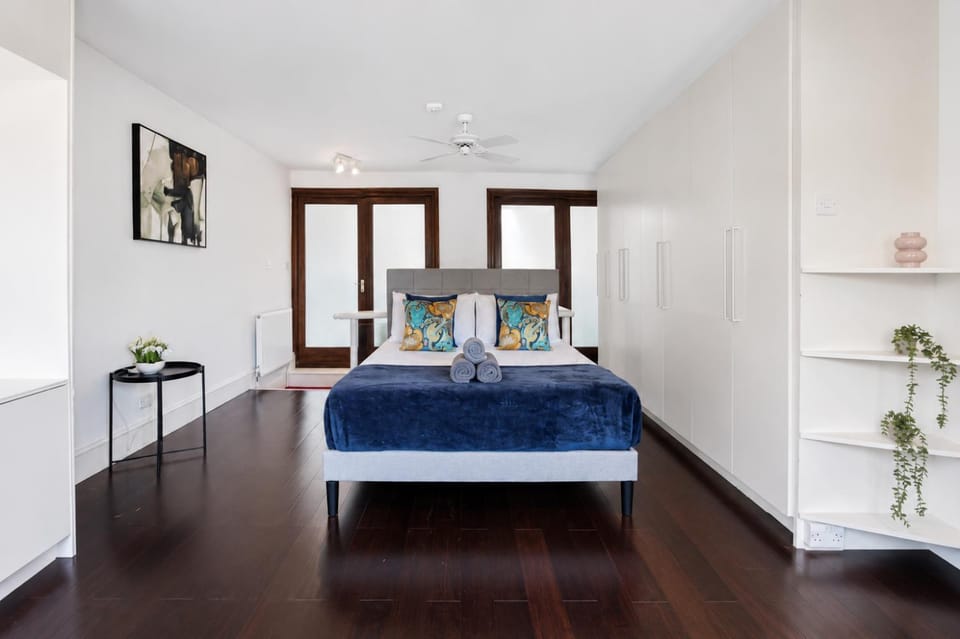 Bed, Bathroom, Photo of the whole room, Decorative detail, Bedroom, flat iron, hair dryier, towels, wardrobe