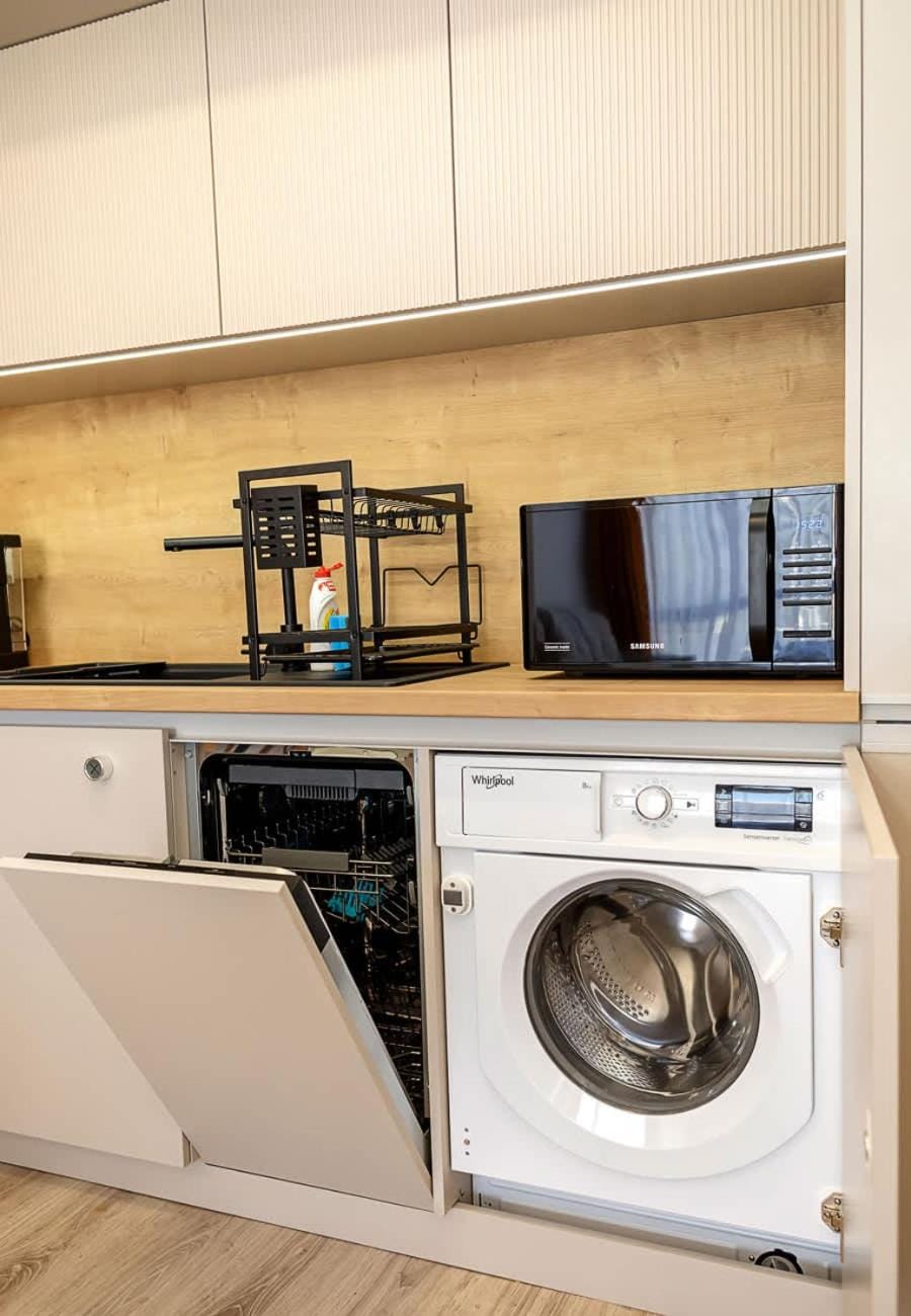 Kitchen or kitchenette, dishwasher, microwave, stove, washing machine