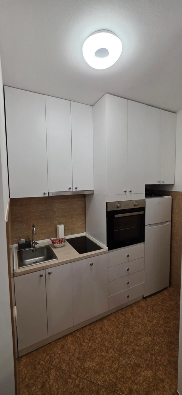 Kitchen or kitchenette, dishwasher, oven, stove