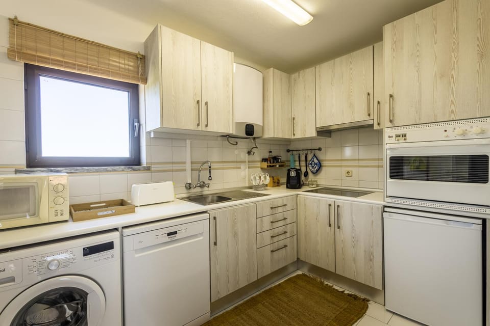 Kitchen or kitchenette, dishwasher, oven, stove, toaster, washing machine