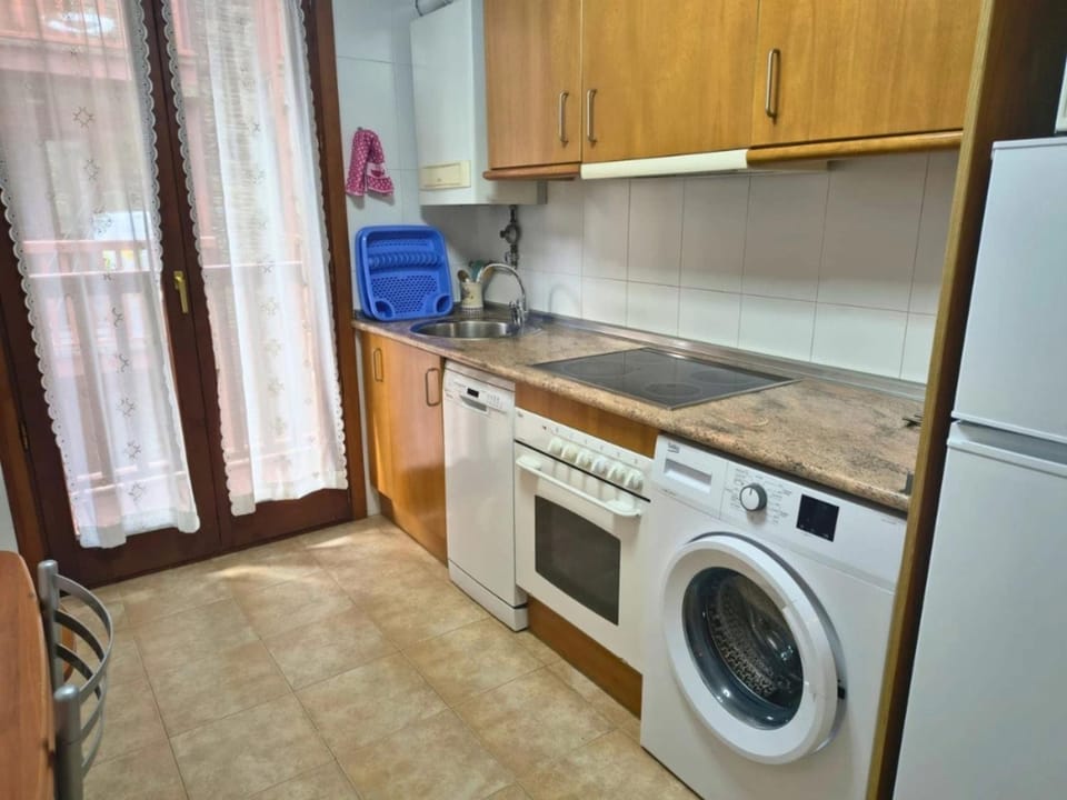 Kitchen or kitchenette, dishwasher, oven, stove, washing machine