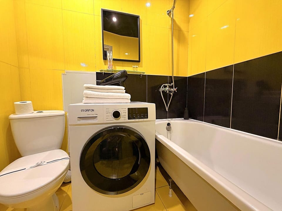 Toilet, Bathroom, Bath, hair dryier, towels, washing machine, dryer